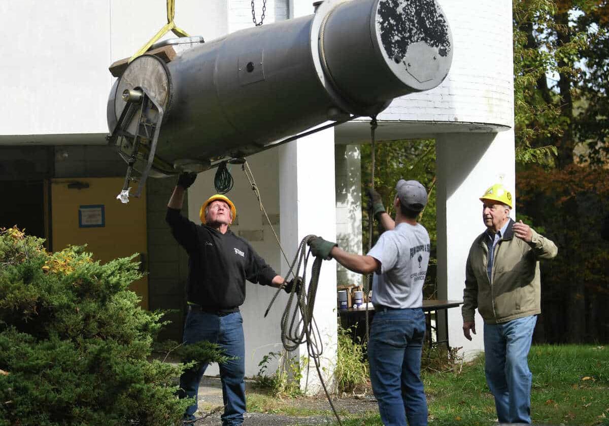 Hoist Workers from Frank Compo & Sons remove the Gregory-Maksutov Telescope from the observatory at the Stamford Museum & Nature Center in Stamford, Conn. Tuesday, Oct. 18, 2022. The removal of the 1965 telescope is the first step in the Stamford Museum & Nature Center's plan to demolish the decommissioned observatory and begin construction on the new Planetarium & Astronomy Center. The old telescope is being transported to the Astronomical Lyceum, a historical telescope museum in New Mexico.